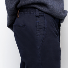 Load image into Gallery viewer, Navy pants worn by a person on a white background