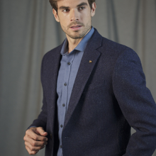 Load image into Gallery viewer, Man wearing a dark blue blazer over a light blue shirt against a gray background