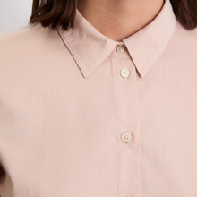 Load image into Gallery viewer, Close-up of a light pink shirt with buttons on a plain background