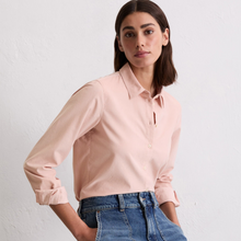 Load image into Gallery viewer, Woman wearing a light pink blouse and blue jeans against a white background