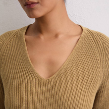Load image into Gallery viewer, Close-up of a person wearing a beige knit sweater against a neutral background