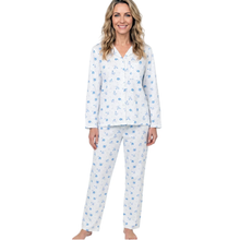 Load image into Gallery viewer, A woman modeling a two-piece long-sleeve pajama set with a white base and a light blue floral pattern, set against a plain white background.