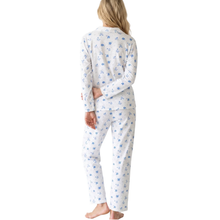 Load image into Gallery viewer, A woman shown from the back wearing a matching long-sleeve pajama set with a white base and a small blue floral pattern, photographed against a plain white studio background.