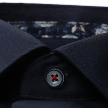 Load image into Gallery viewer, Close-up of a navy blue shirt with a patterned lining and button detail.