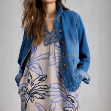 Load image into Gallery viewer, Woman wearing a blue denim jacket over a patterned dress on a plain background