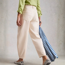Load image into Gallery viewer, Back lower view oof model wearing White Stuff Aubrey Barrel Leg Jean in white, with a light grey background.