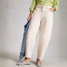 Load image into Gallery viewer, Front lower view oof model wearing White Stuff Aubrey Barrel Leg Jean in white, with a light grey background.