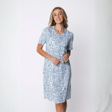 Load image into Gallery viewer, Woman wearing a light blue floral dress against a white background