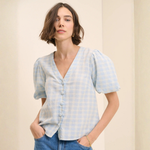 Load image into Gallery viewer, Woman wearing a light blue striped shirt against a beige background