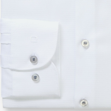 Load image into Gallery viewer, Close-up of a white dress shirt with buttons on a light gray background