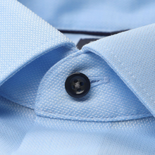 Load image into Gallery viewer, Close-up of a light blue shirt with a button