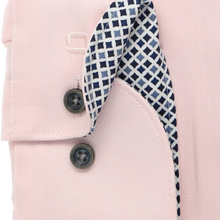 Load image into Gallery viewer, Close-up of a light pink shirt or jacket fabric with two dark buttons and a folded patterned inner lining showing a navy, white, and light blue diamond grid design.