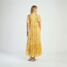Load image into Gallery viewer, Woman wearing a yellow floral dress on a white background