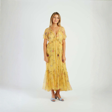 Load image into Gallery viewer, Woman wearing a yellow floral dress on a white background