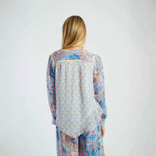 Load image into Gallery viewer, Woman wearing a patterned dress with a plain background
