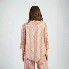 Load image into Gallery viewer, Woman wearing a patterned outfit on a plain background