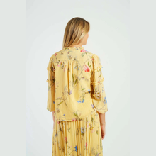 Load image into Gallery viewer, Woman wearing a yellow floral dress on a white background