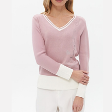 Load image into Gallery viewer, A woman wearing a dusty pink V-neck knit sweater with white contrast trim at the neckline and cuffs, paired with white pants, against a plain white background.