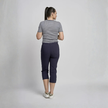 Load image into Gallery viewer, Woman wearing a striped shirt and navy capri pants on a plain background