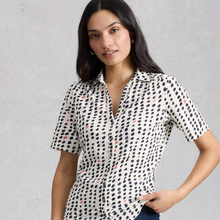 Load image into Gallery viewer, Close up of Model posing wearing White Stuff Ann SS Jersey Shirt, with a light grey background.