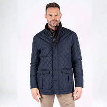 Load image into Gallery viewer, Man wearing a navy quilted jacket on a white background