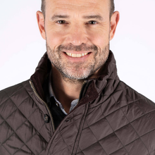 Load image into Gallery viewer, Man wearing a brown quilted jacket on a white background