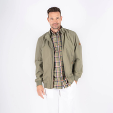 Load image into Gallery viewer, Man wearing a green jacket over a plaid shirt on a white background