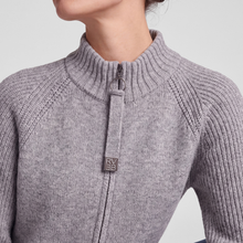Load image into Gallery viewer, Close-up of a person wearing a light heather gray ribbed knit half-zip sweater with a small square metal logo patch on the zipper pull.