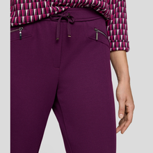 Load image into Gallery viewer, Purple pants with a patterned top on a light gray background