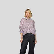 Load image into Gallery viewer, Woman wearing a striped shirt and black pants on a gray background