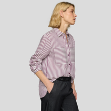 Load image into Gallery viewer, Woman wearing a striped shirt and dark pants on a plain background