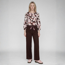 Load image into Gallery viewer, Woman in top and trouser on grey background