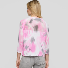 Load image into Gallery viewer, Woman wearing a pink and gray tie-dye shirt on a plain background