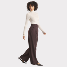 Load image into Gallery viewer, Woman wearing a white turtleneck and brown wide-leg pants on a light gray background
