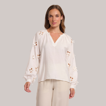 Load image into Gallery viewer, Mid view of model wearing the Rino & Pelle Long Balloon Sleeve Blouse, With a grey background.