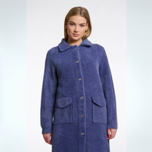 Load image into Gallery viewer, Woman wearing a blue coat on a light gray background