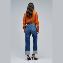 Load image into Gallery viewer, Rear of lady in jeans with orange shirt and heels