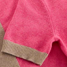 Load image into Gallery viewer, Close-up of a pink knit garment with a contrasting beige ribbed cuff.