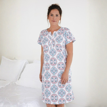 Load image into Gallery viewer, Woman wearing a patterned nightshirt in a bedroom setting