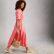 Load image into Gallery viewer, Woman wearing a pink tie-dye dress holding a straw bag against a plain background