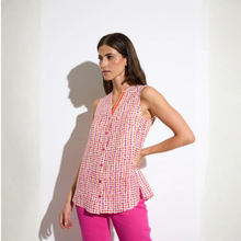 Load image into Gallery viewer, Posed left front view of model wearing Tinta Sleeveless Shirt in coral pink, with a white background.