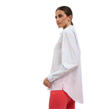 Load image into Gallery viewer, Woman wearing a white patterned shirt and red pants on a white background