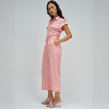 Load image into Gallery viewer, Woman wearing a pink jumpsuit on a plain background