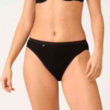 Load image into Gallery viewer, A close up of a model wearing the Sloggi Tai Brief in Black. 
