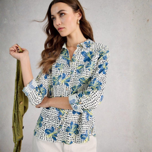 Load image into Gallery viewer, Woman wearing a floral blouse with a gray background