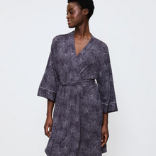 Load image into Gallery viewer, Woman wearing a dark floral patterned robe on a white background