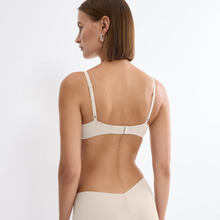 Load image into Gallery viewer, Woman wearing a beige bra on a plain background