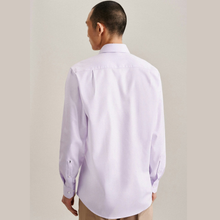 Load image into Gallery viewer, A man viewed from the back wearing a light lavender long-sleeve button-down dress shirt and tan trousers, set against a plain beige studio background.