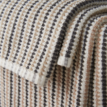 Load image into Gallery viewer, Close-up of textured fabric with a pattern of concentric circles in beige, brown, and black.
