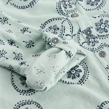 Load image into Gallery viewer, Green shirt with black pattern and buttons on a white background